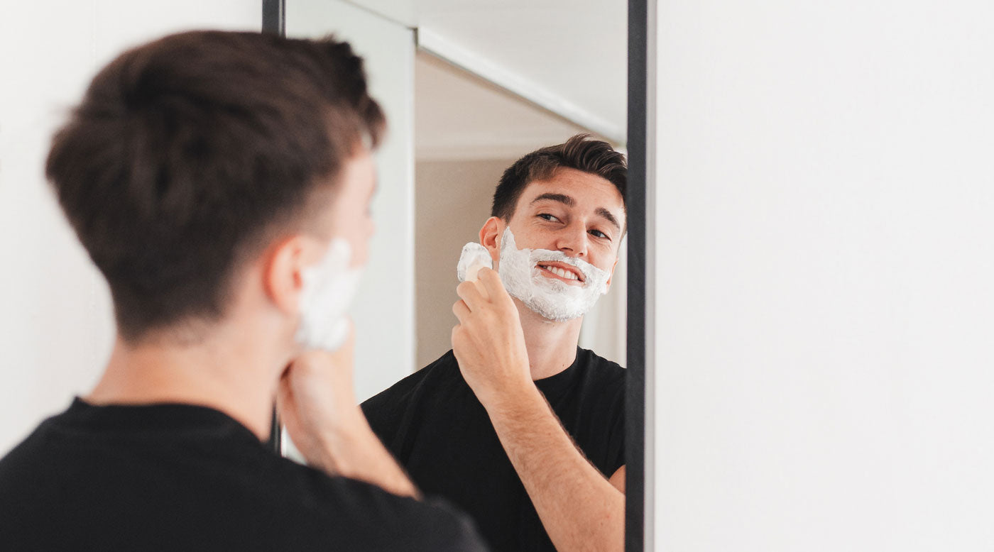 Man shaving in the mirror