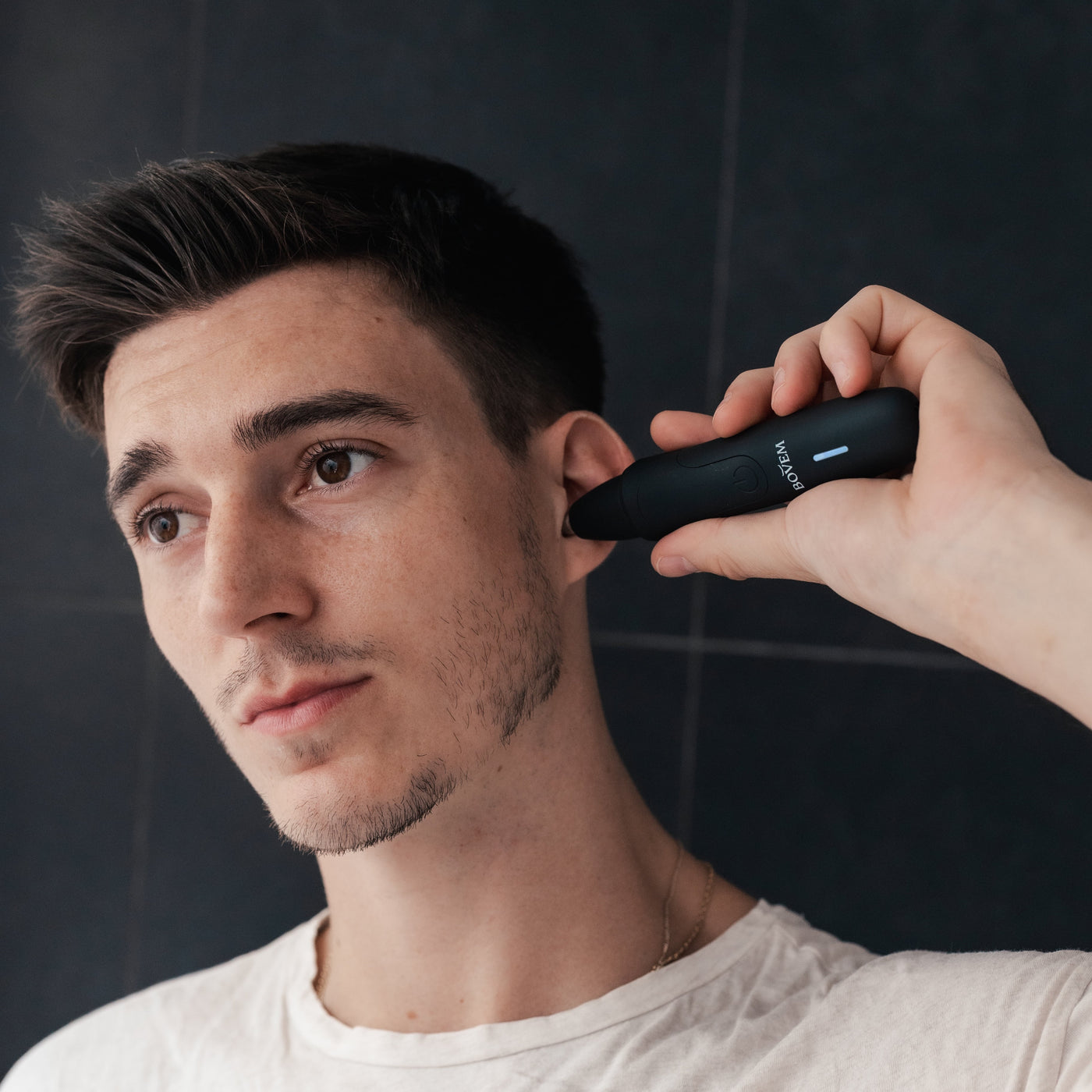 man trimming ear hair